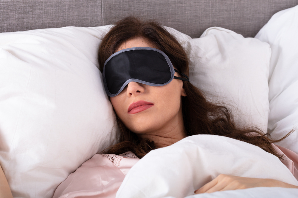 woman in bed getting a healthy amount of sleep