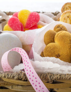 a gift basket filled with heart-shaped cookies