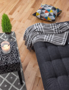 living room sofa, throw blanket and candles