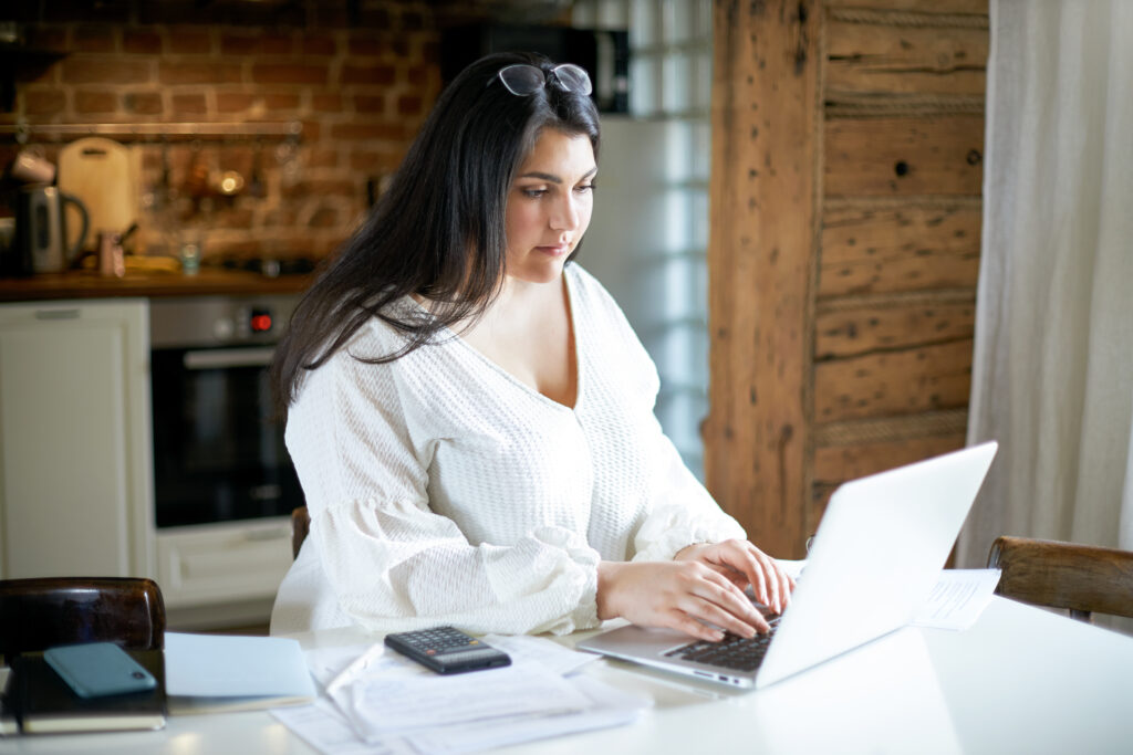 homeowner calculating solar energy savings on laptop