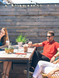 people socializing on a rooftop deck