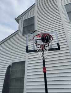 a basketball going into an IGL travel hoop