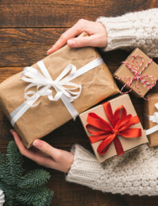 woman holding wrapping holiday gifts