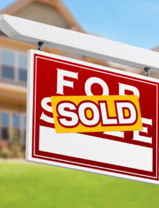 a sold sale in front of a home