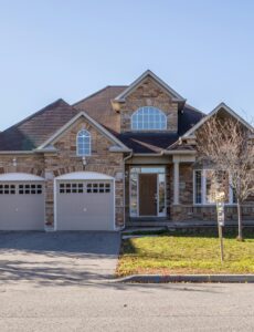 a front face of a tidy brick home