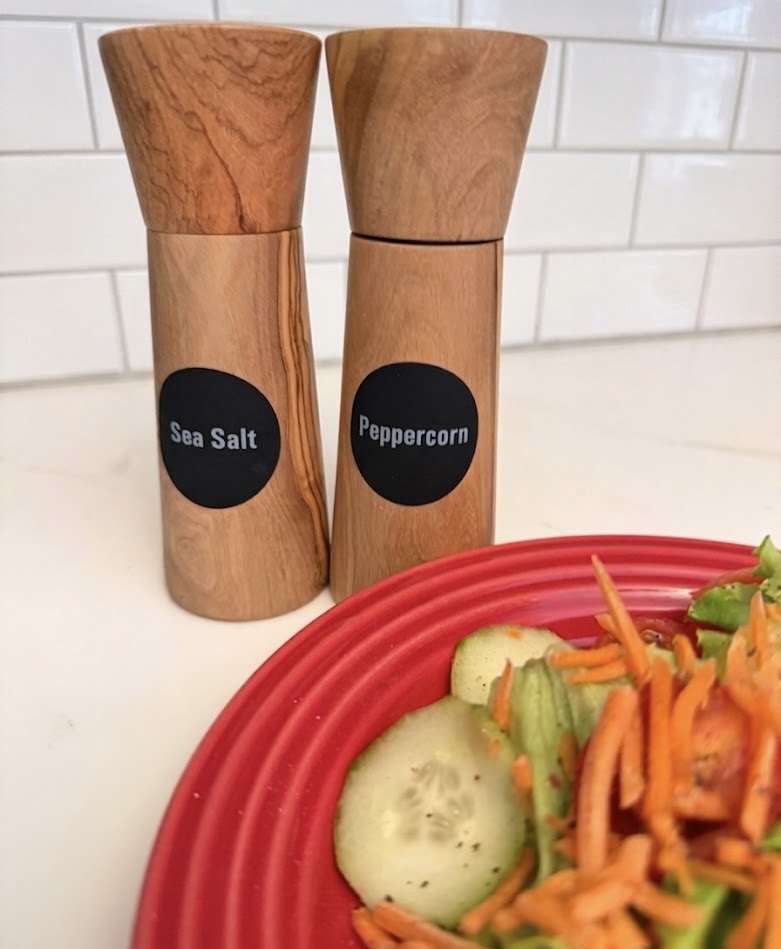 salt, pepper, grinders, salad, plate, backsplash
