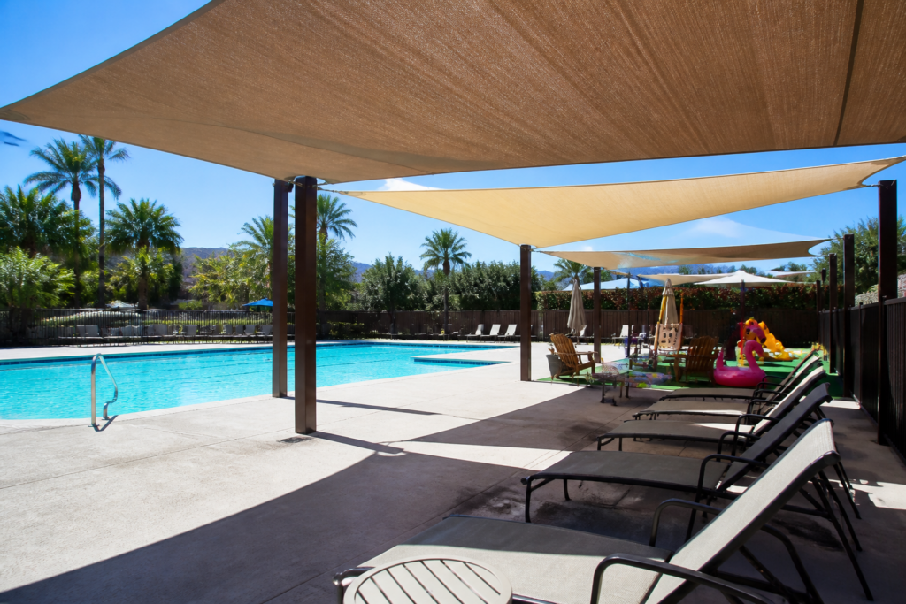 shade structures over lounge chairs by pool