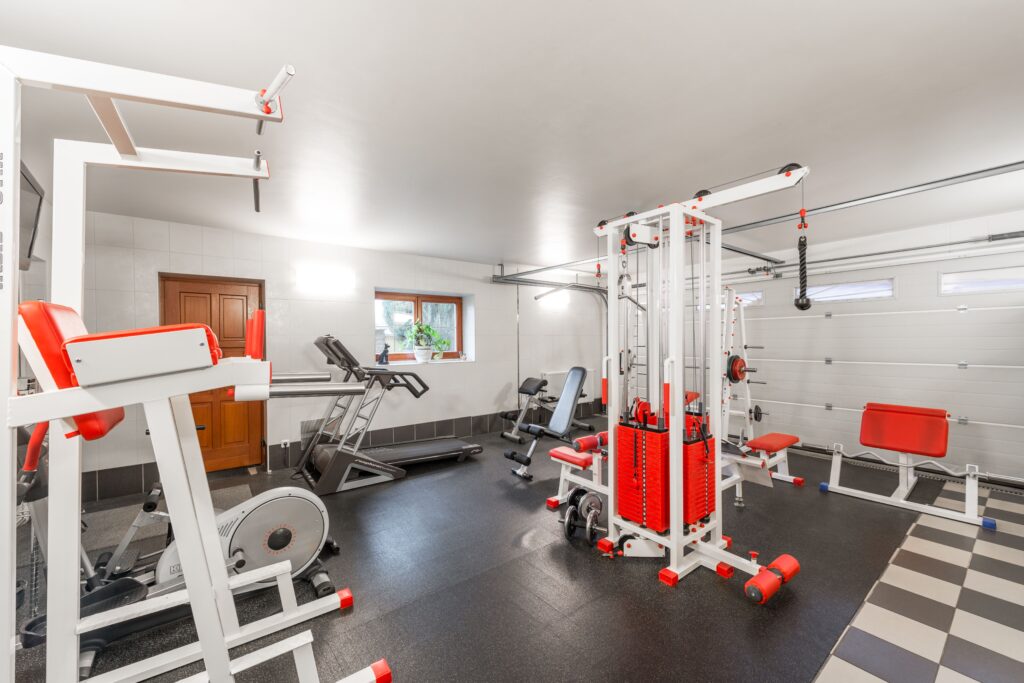 a home gym setup with modern exercise equipment in a garage