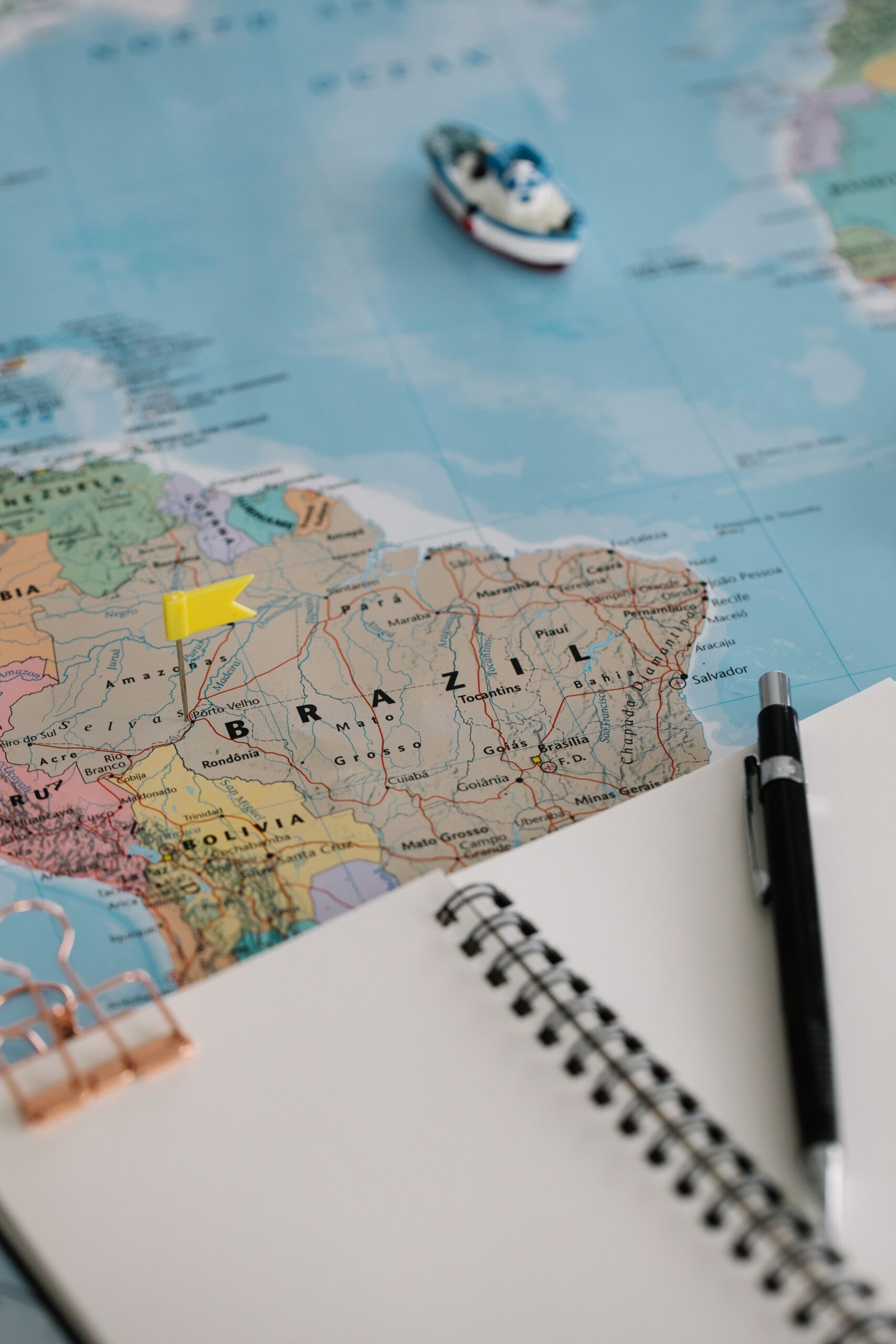 colorful map with a notebook and pen on it