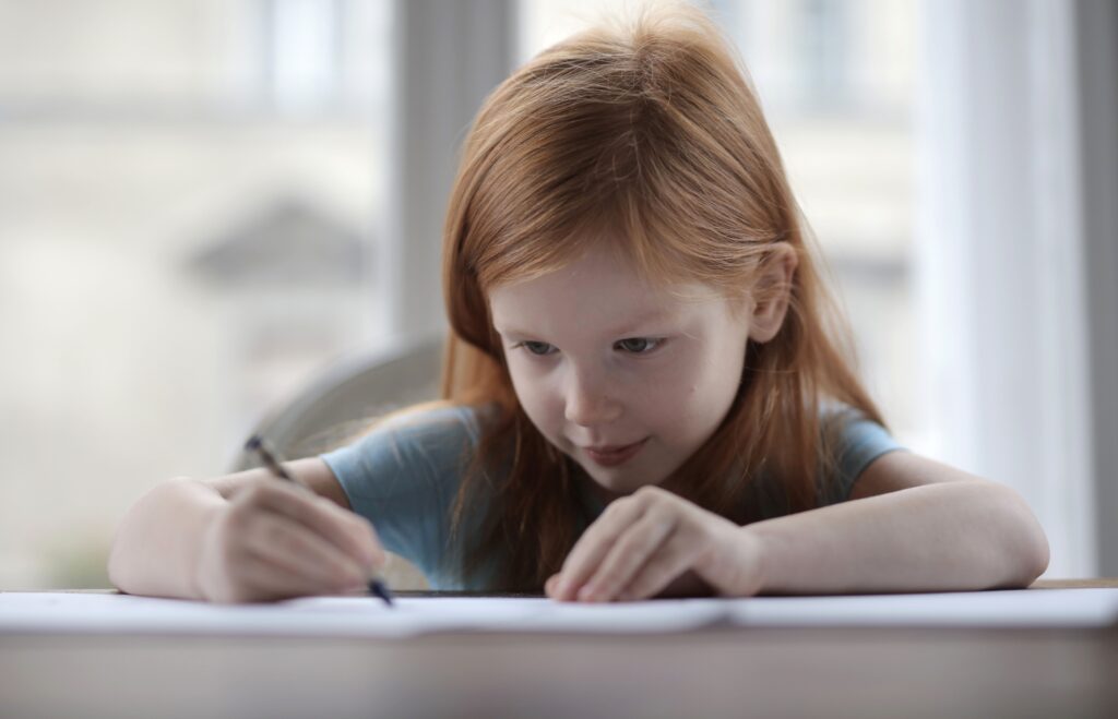 young girl writing a story
