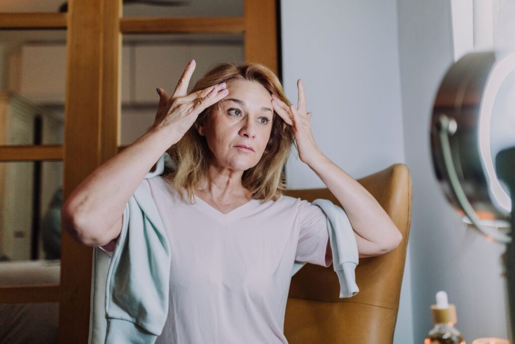 A woman practicing her skincare routine.