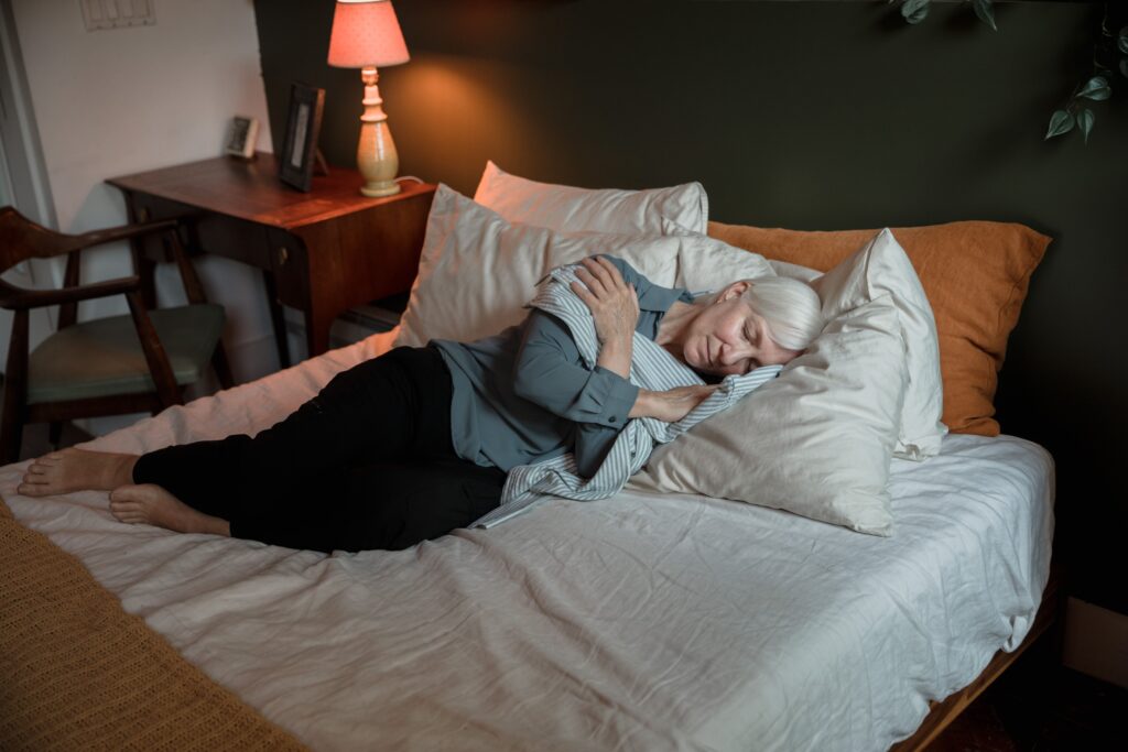 Woman sleeping peacefully in a cozy bedroom.