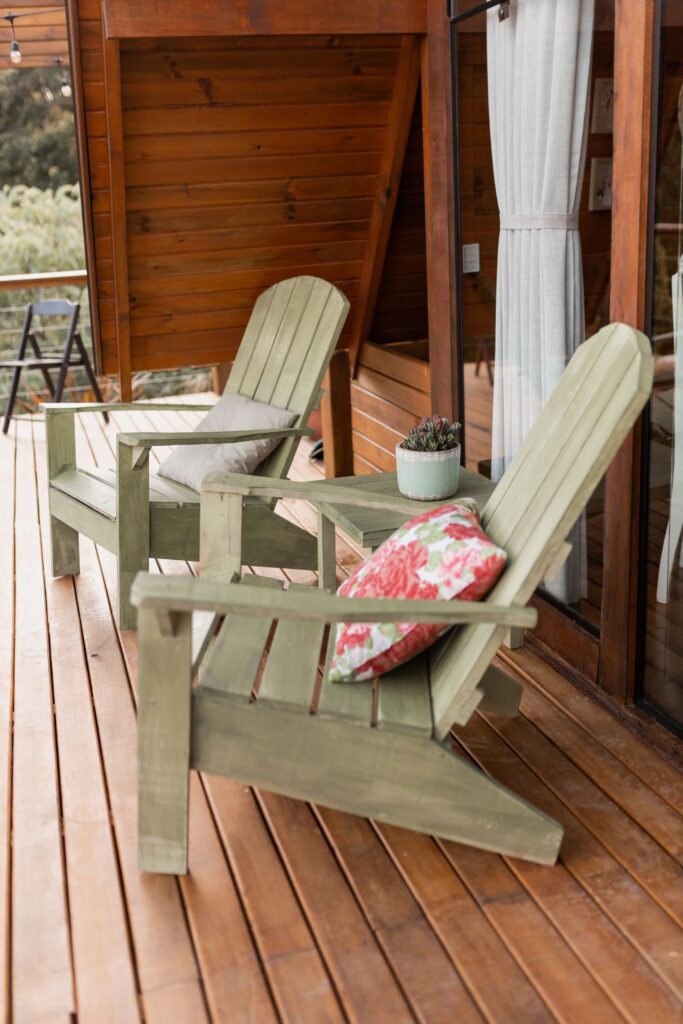green Adirondack chairs on a deck