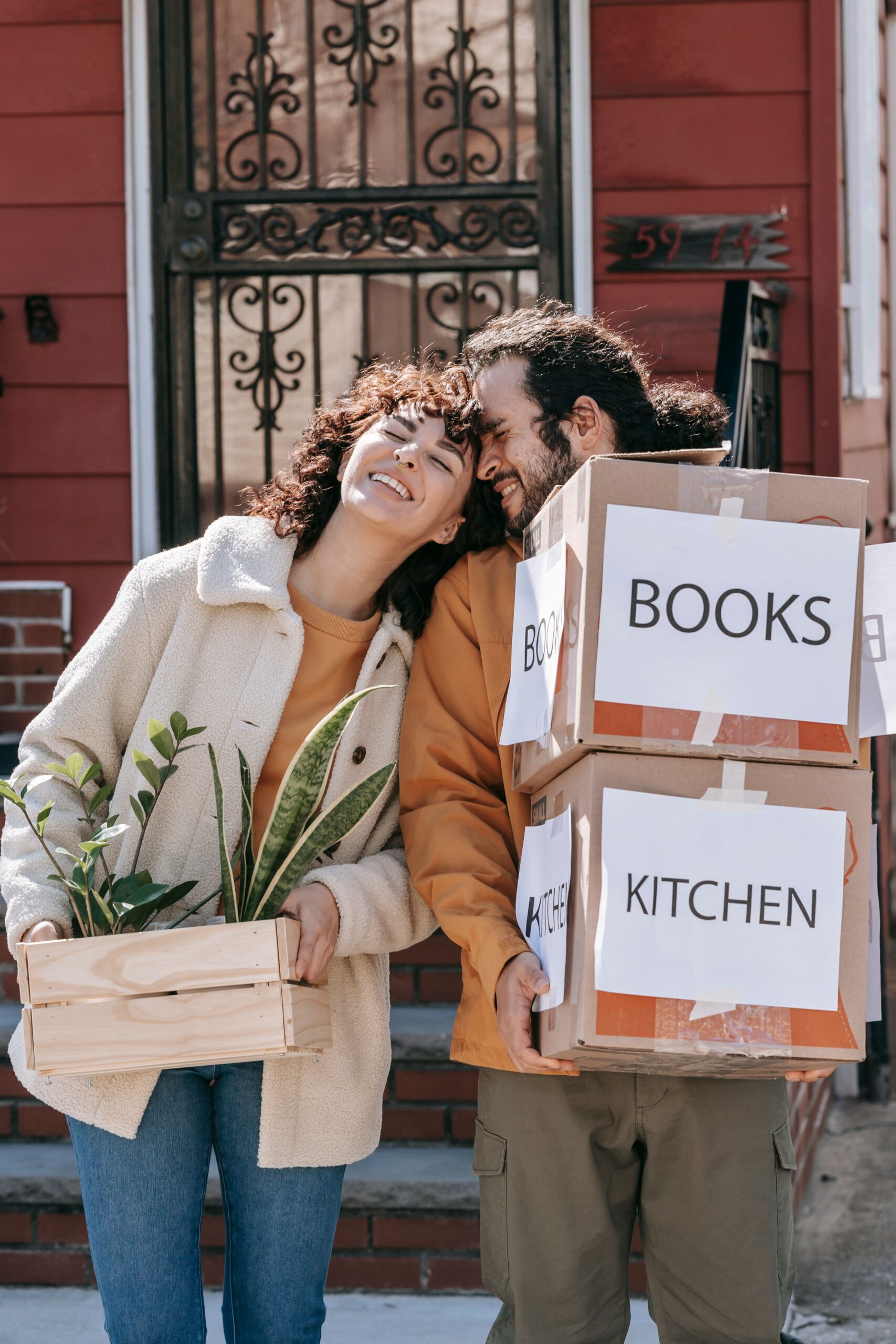 happy couple with moving boxes