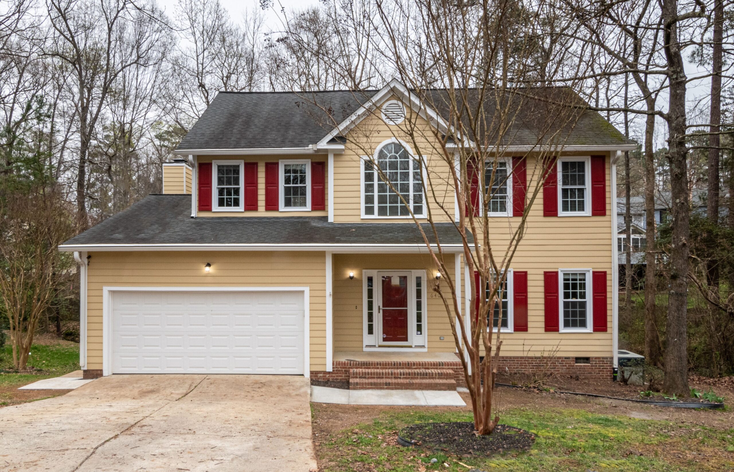 A older two-story home with an aging roof
