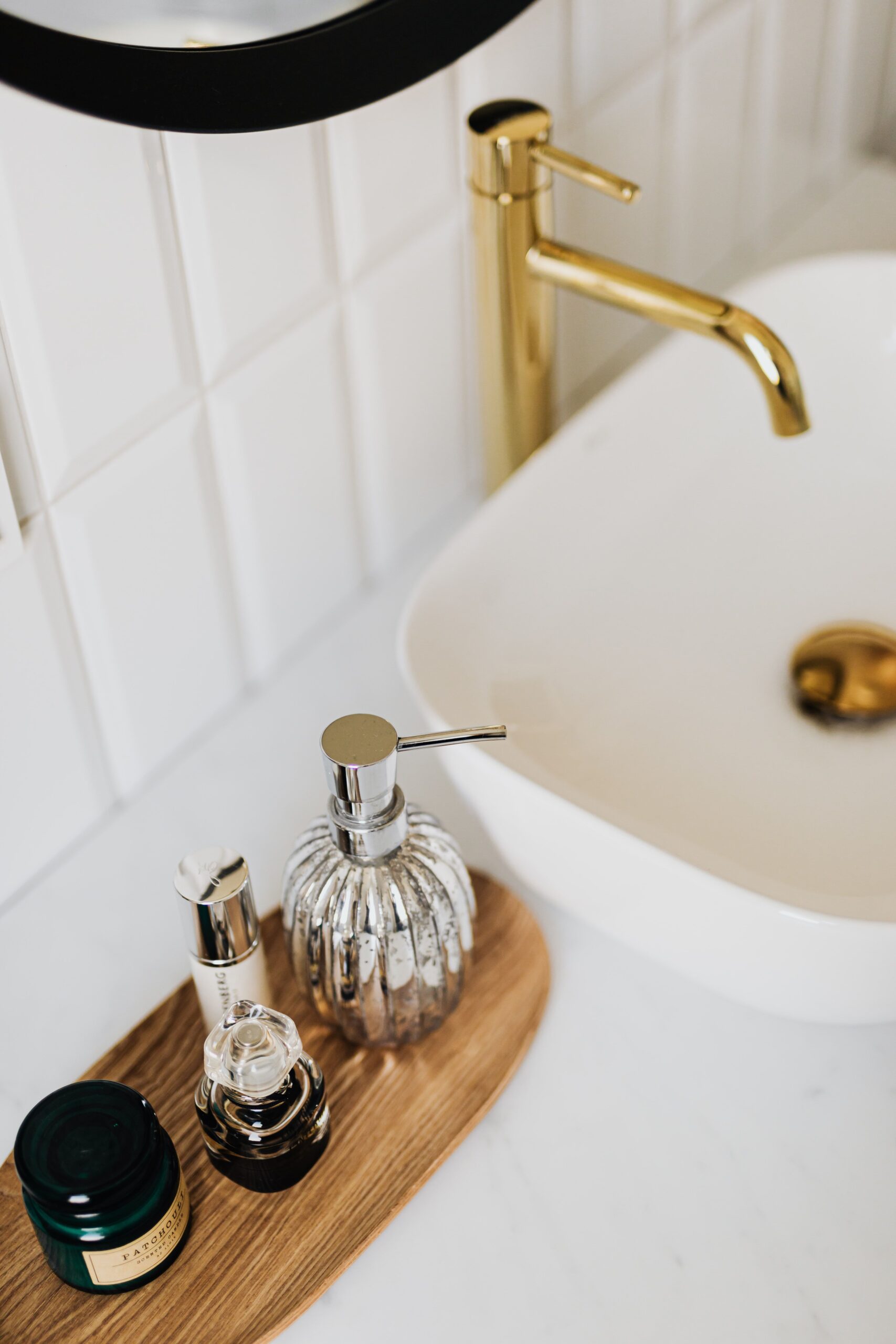 white vessel sink with a gold faucet
