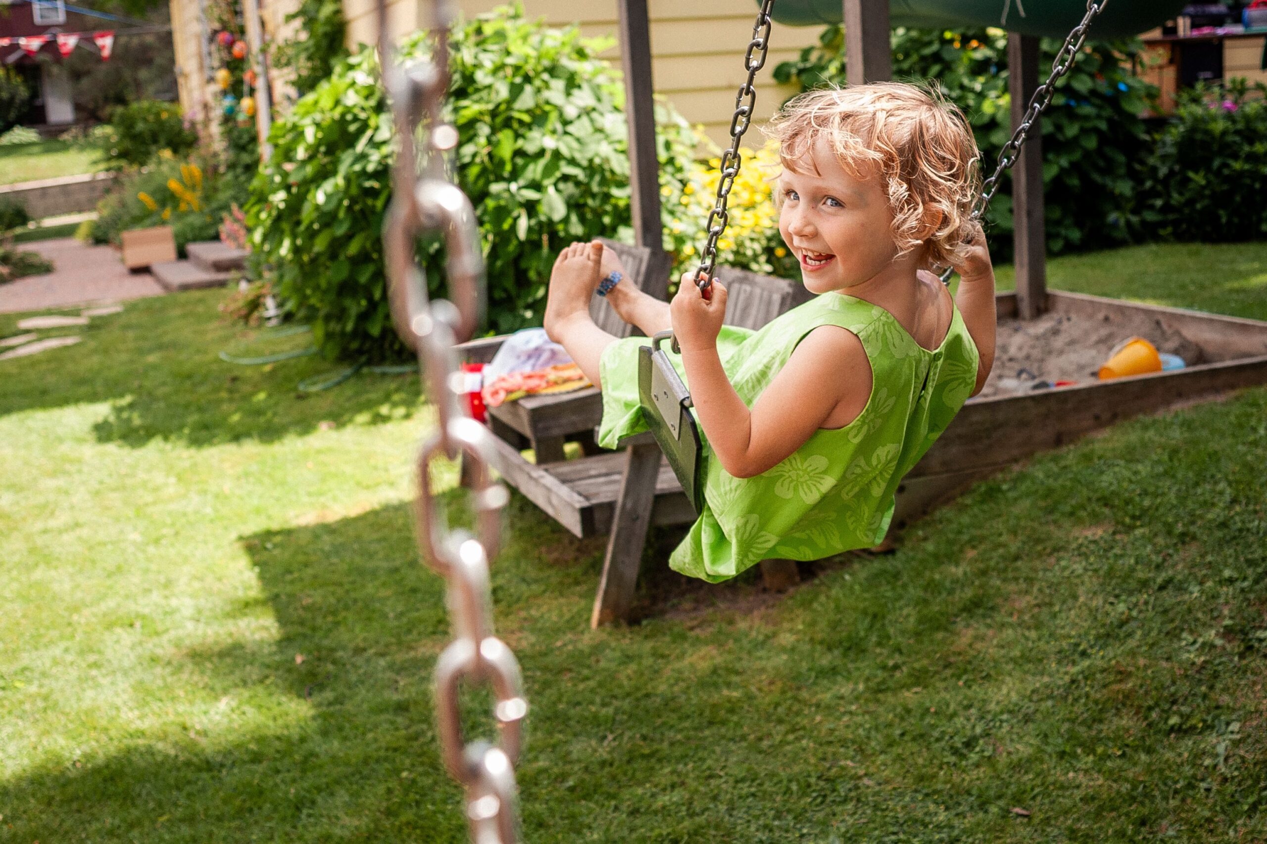 girl on a swing in a backyard